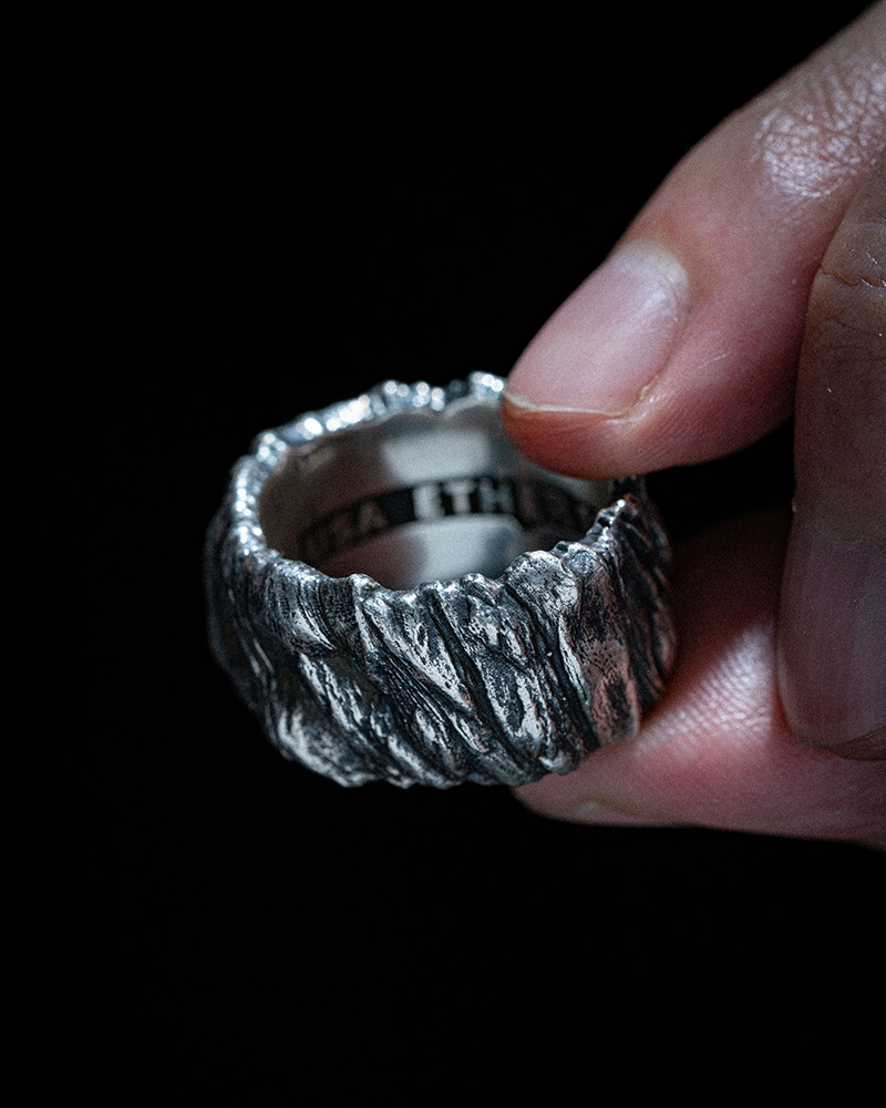 Hand wearing the sterling silver Stone Cliff Band by Ether Eleven.
