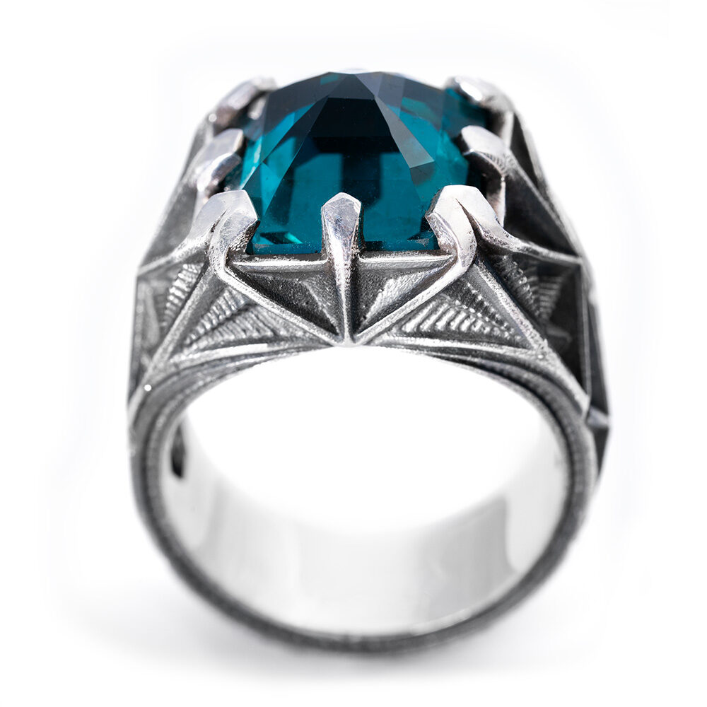 The Arrival Ring in oxidized sterling silver, set with a 13mm custom-cut nano Paraiba tourmaline in sculpted claw prongs, from the Ether Eleven M31 collection.