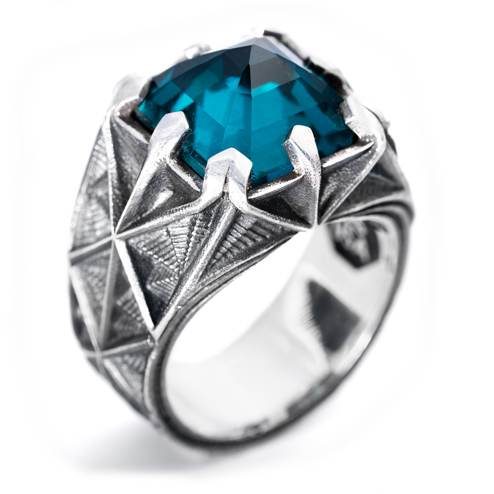 The Arrival Ring from the opposite side, showing the radiating engraved facets across the oxidized silver shank.