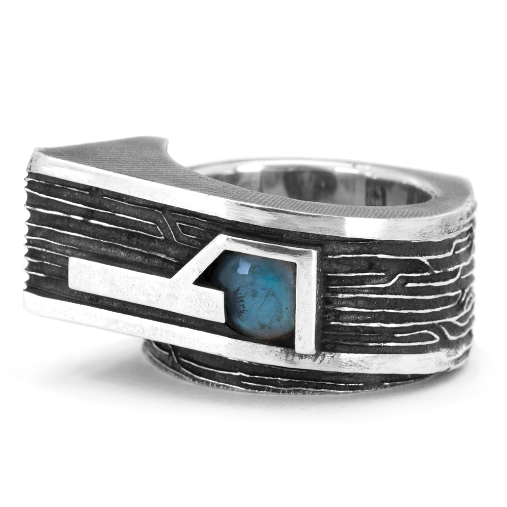 Close-up detail of the labradorite cabochon flashing blue inside the Gravity Ring's carved sterling silver setting.
