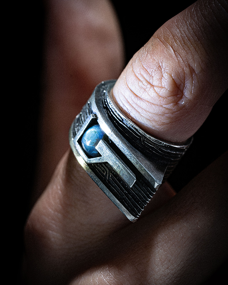 Gravity Ring worn on the hand, showing the scale of the brutalist sterling silver ring and its labradorite stone.