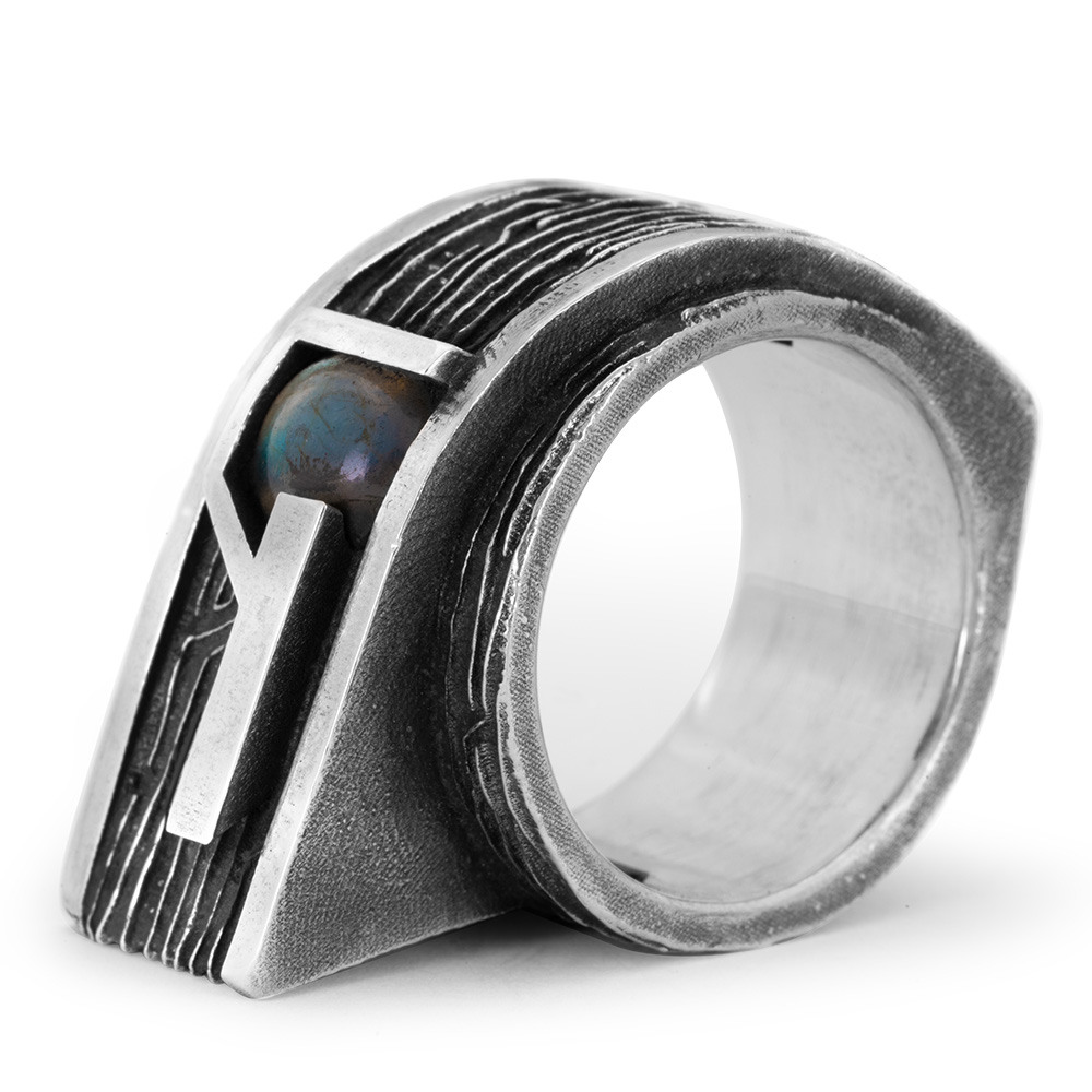 Side view of the Gravity Ring showing the layered brutalist silhouette and labradorite cabochon in its geometric sterling silver setting.