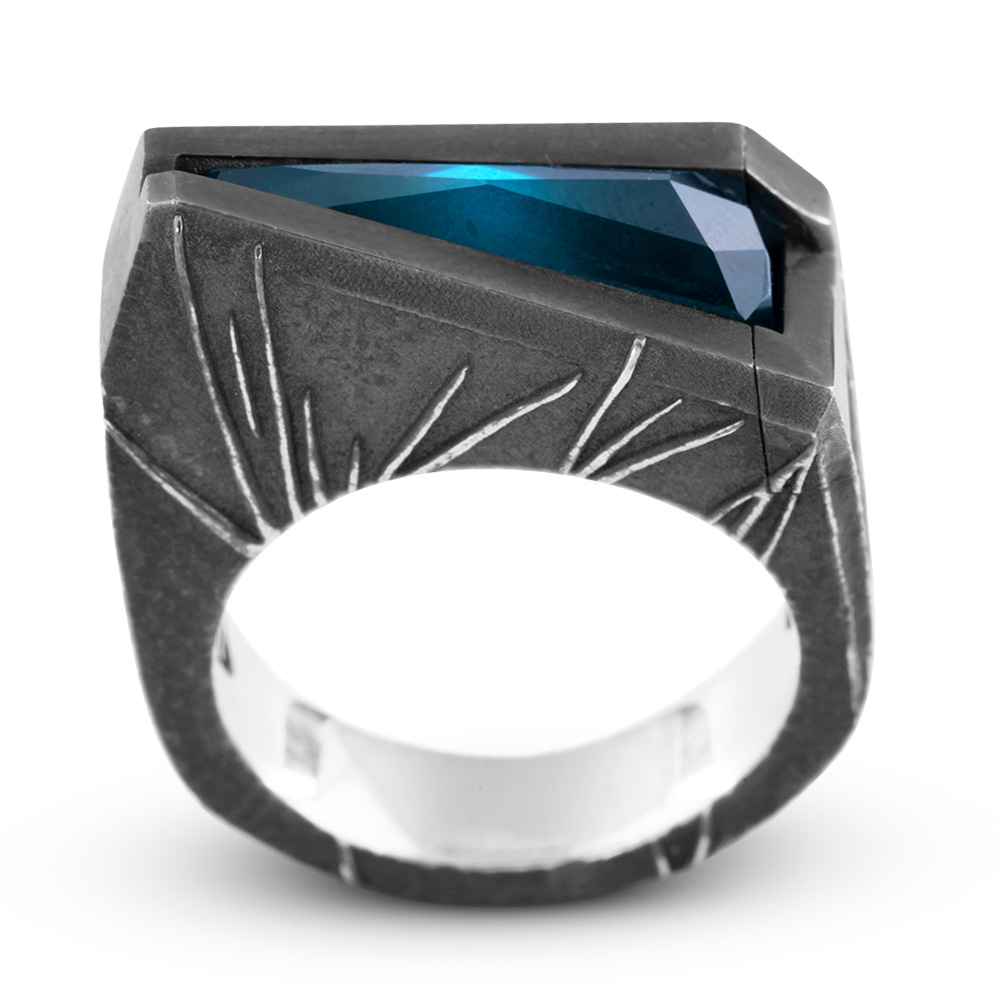 Front view of the Momentum Ring showing symmetrical sunburst engraving on both shoulders beneath the angled Paraiba tourmaline.