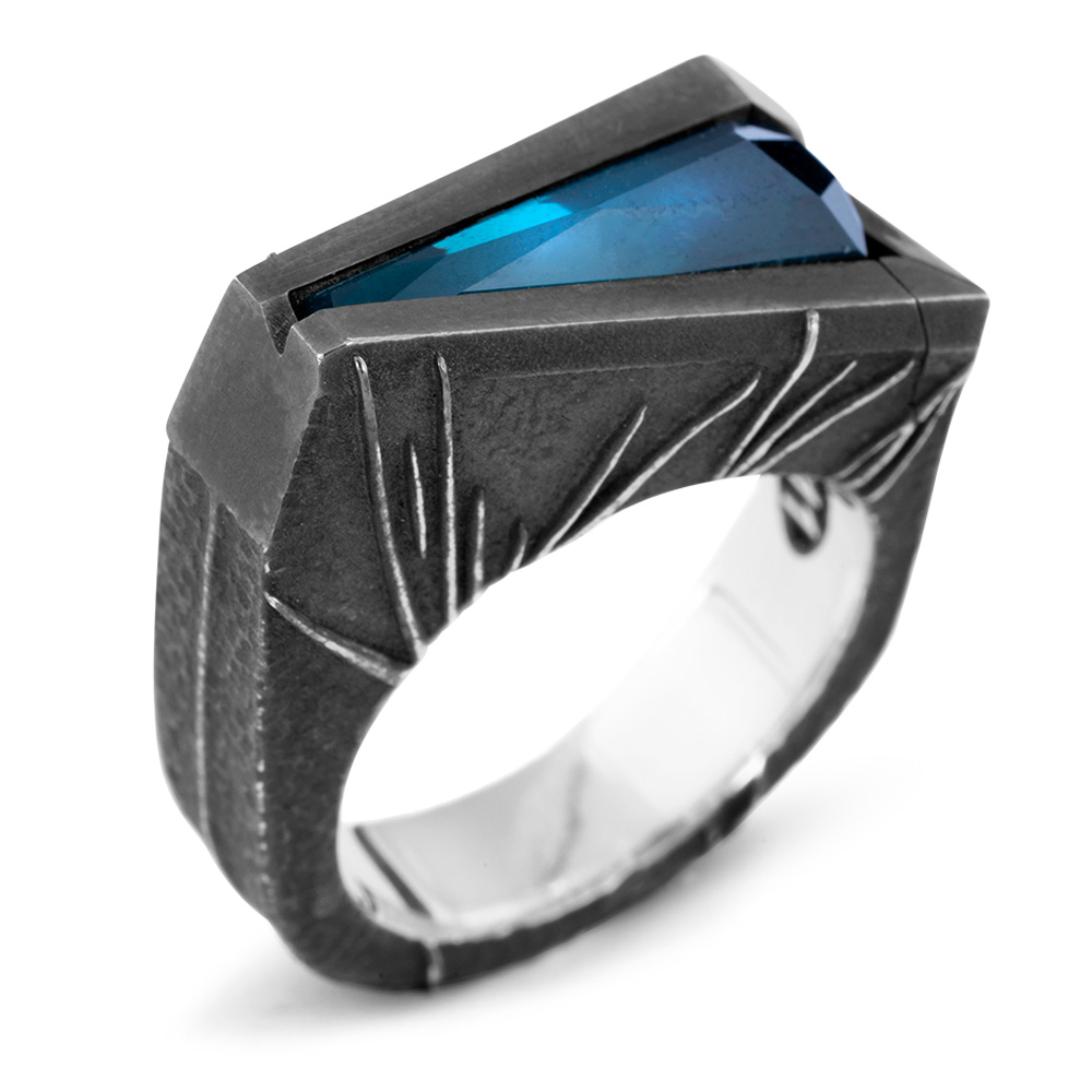 The Momentum Ring from the opposite side, showing the wedge silhouette and the full length of the Paraiba tourmaline in its channel setting.