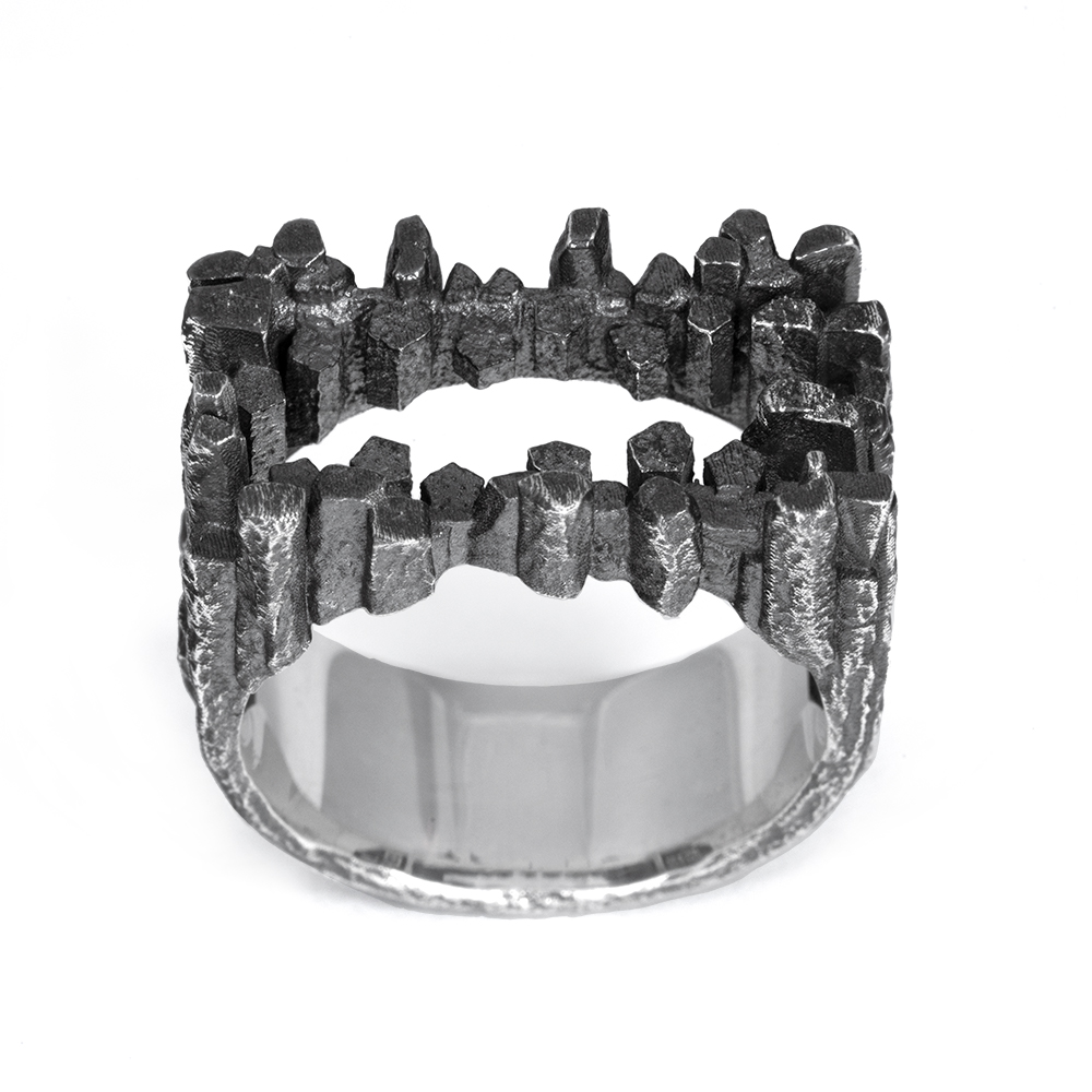 Top-down view of the Stone Tower Frame Ring showing twin rows of columnar silver peaks and the open frame between them.