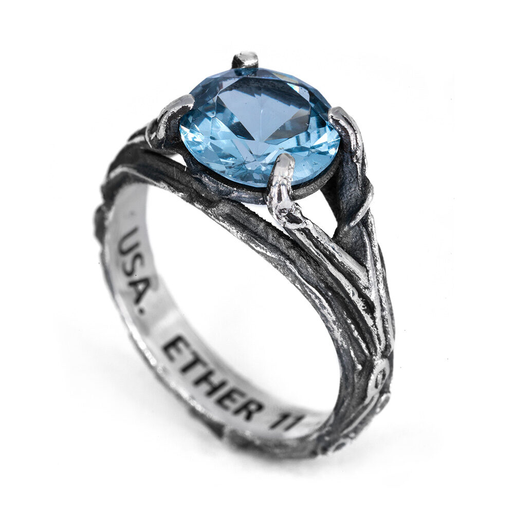 The Vine Ring — hero The Vine Ring in oxidized sterling silver, its branch-like shank set with a faceted aquamarine, from the Ether Eleven Terra collection.
